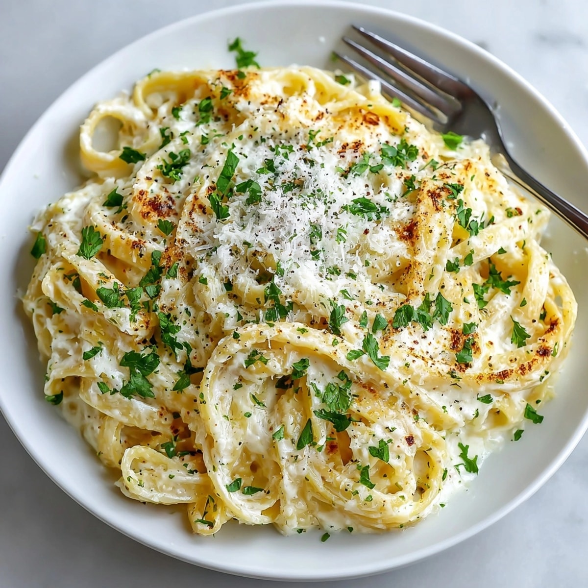 Creamy one-pot Garlic Parmesan Pasta, a ridiculously easy and flavorful Alfredo dish.