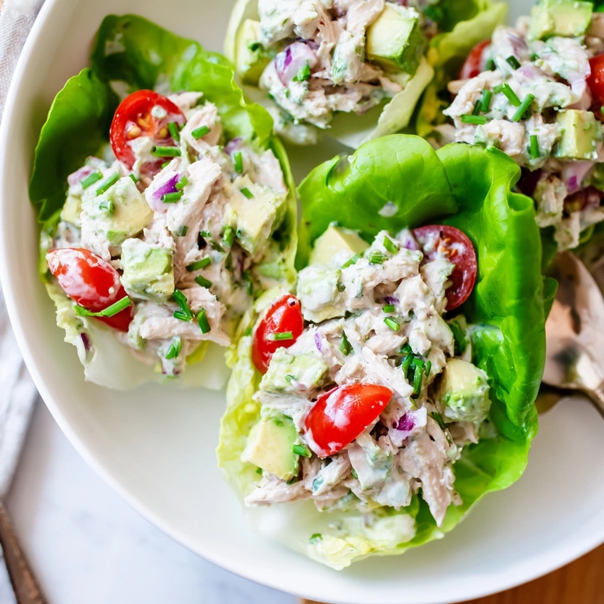 Avocado ranch chicken salad cups piled high in vibrant green lettuce—fresh, flavorful, and light.