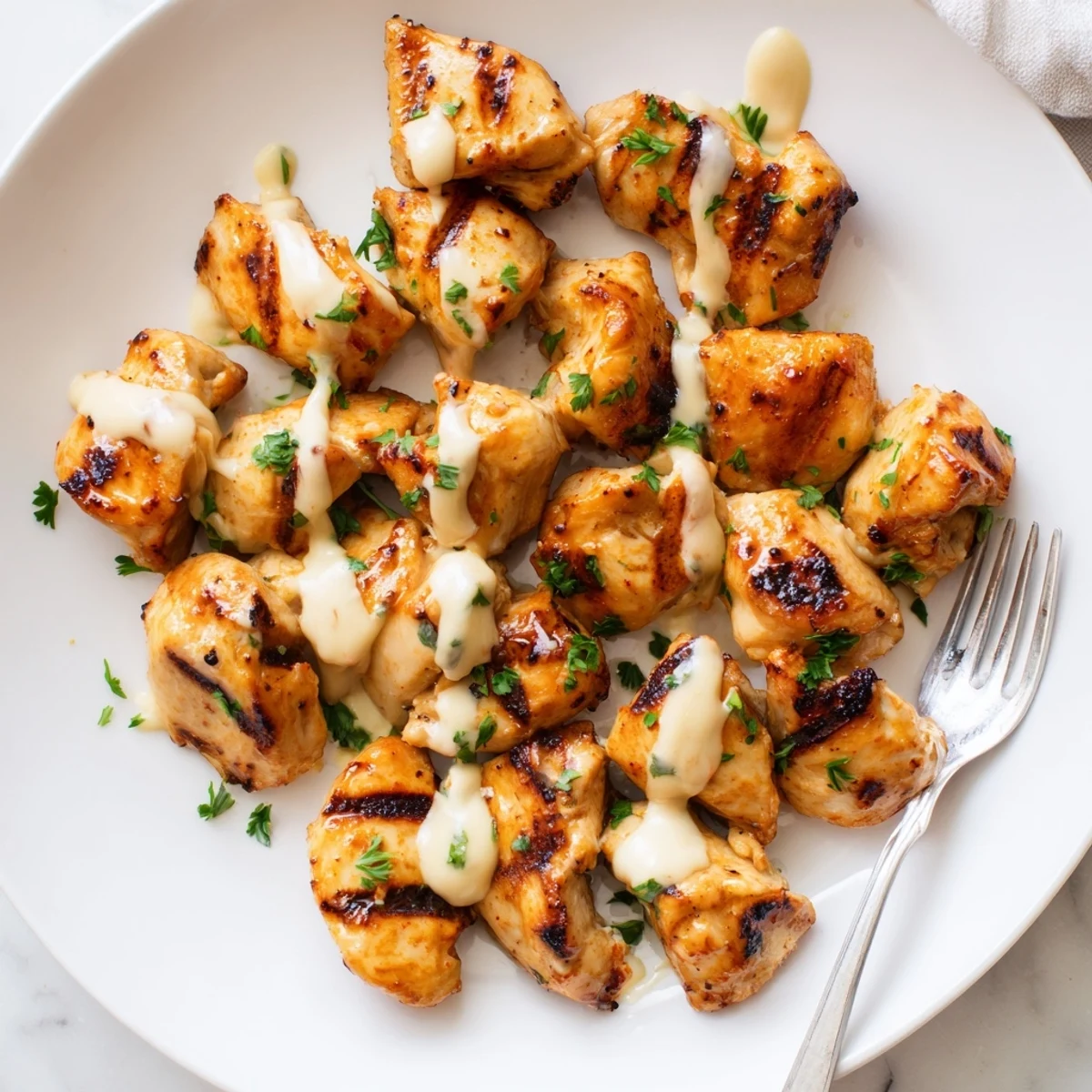 Flavorful Grilled Chicken Bites with Creamy Garlic Sauce perfect for BBQ gatherings.