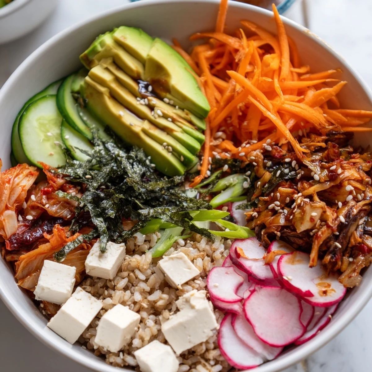 Vibrant fermented vegetable bowl brimming with kimchi, carrots, and cucumbers.  