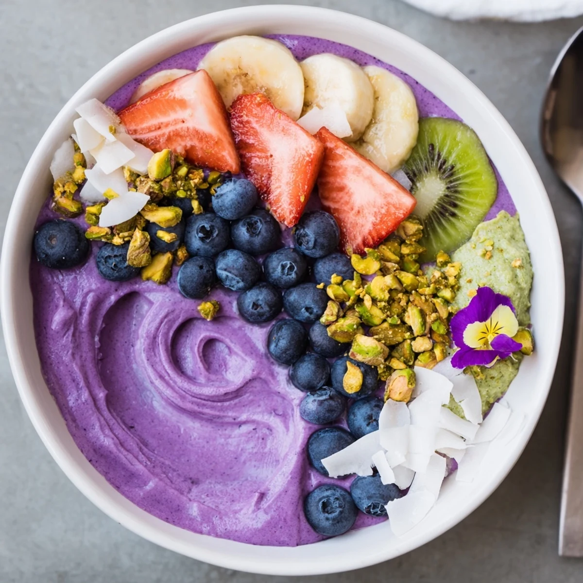 Vibrant smoothie bowls with purple yam and fresh fruit toppings for breakfast delight.  