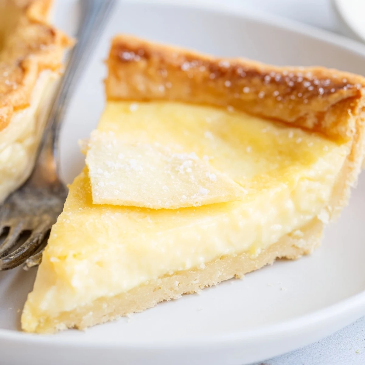 Delicate vanilla water pie slices adorned with fresh berries and whipped cream.  