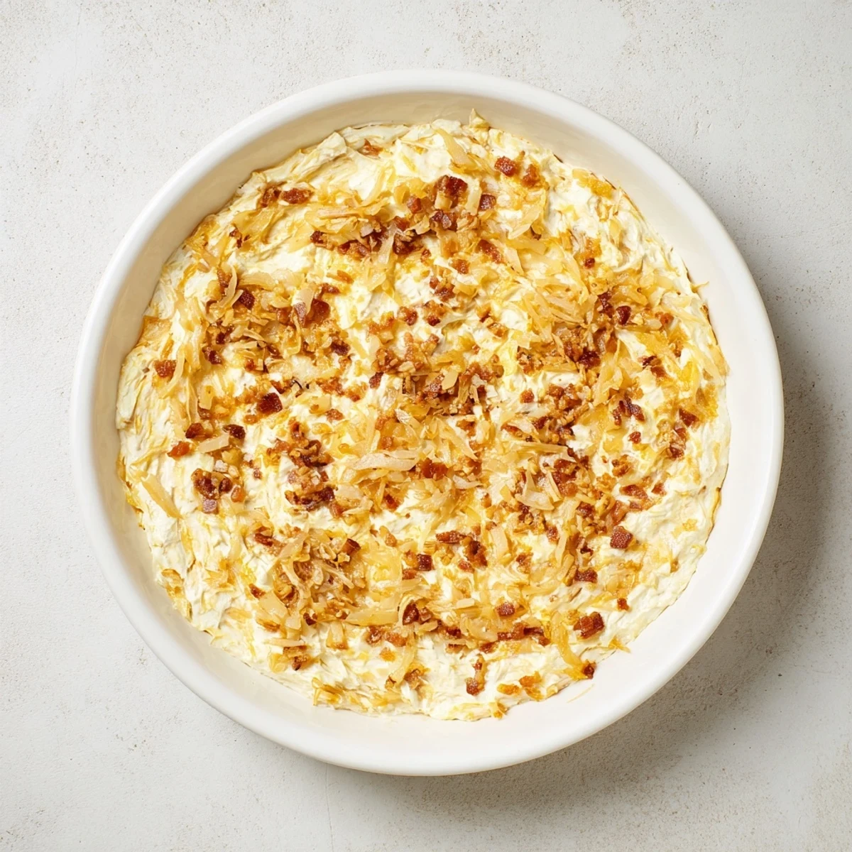 Golden caramelized onion and bacon dip: a creamy, smoky appetizer perfect for sharing with friends.