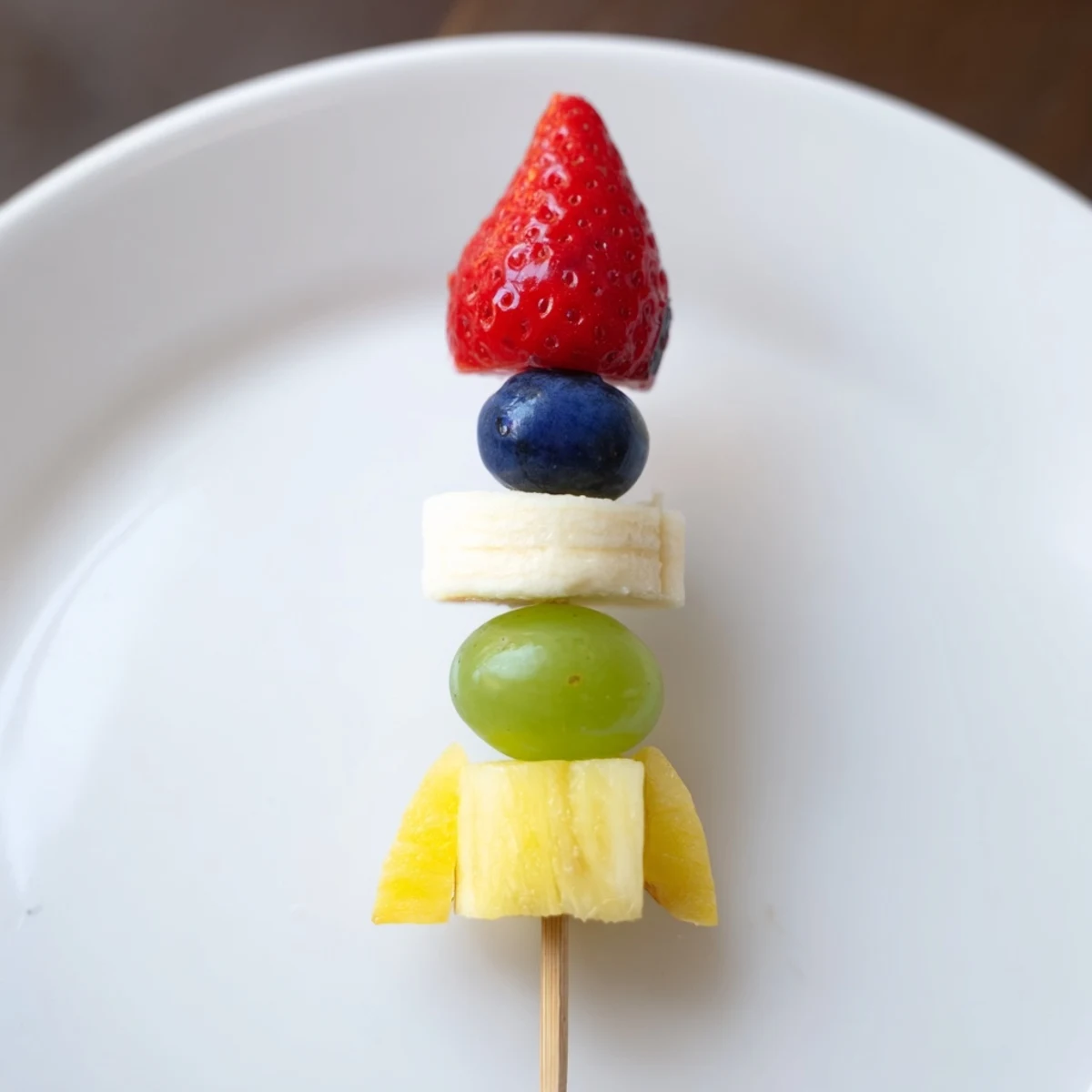 Vibrant Rocket Ship Fruit Skewers with strawberries and grapes ready to serve for a kid's healthy snack.