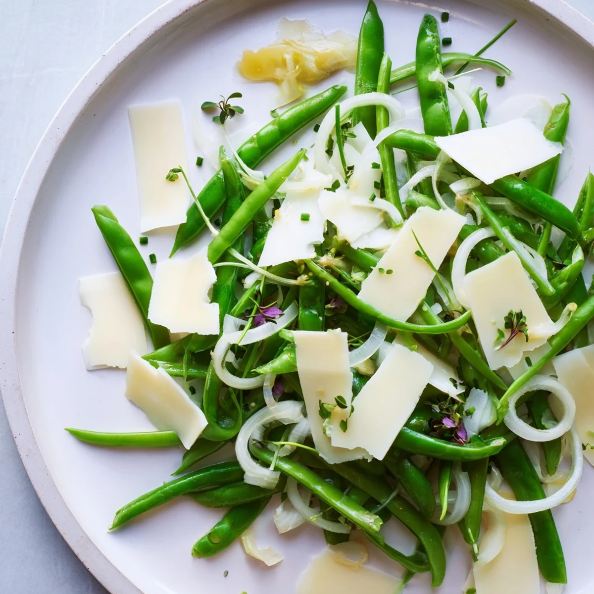 Tempting English Ivy salad: enjoy a vibrant plate of snap peas, green beans, and sharp cheddar.