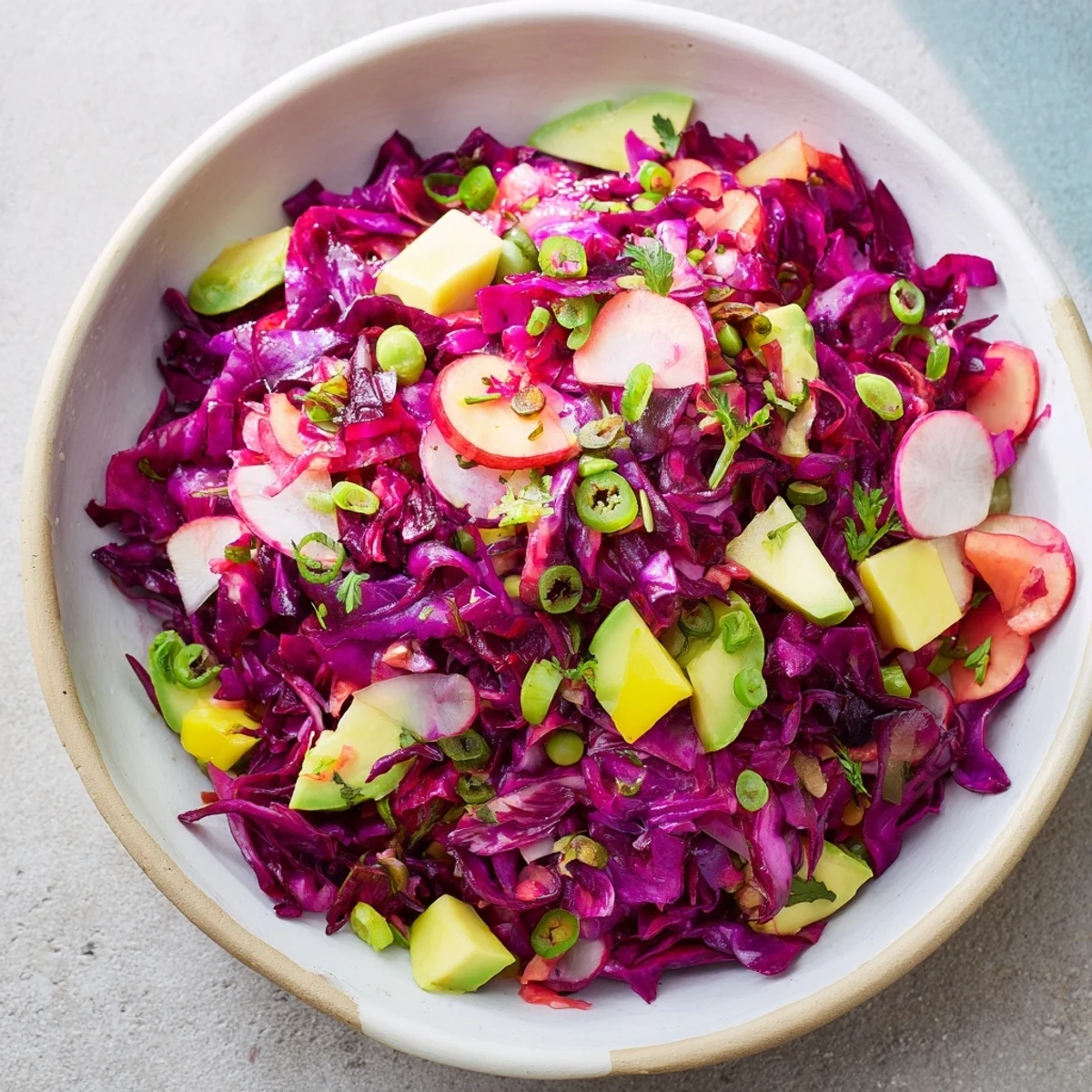 Brightly colored Green Goddess Detox Cabbage Salad, tossed in a zesty dressing and ready to serve.