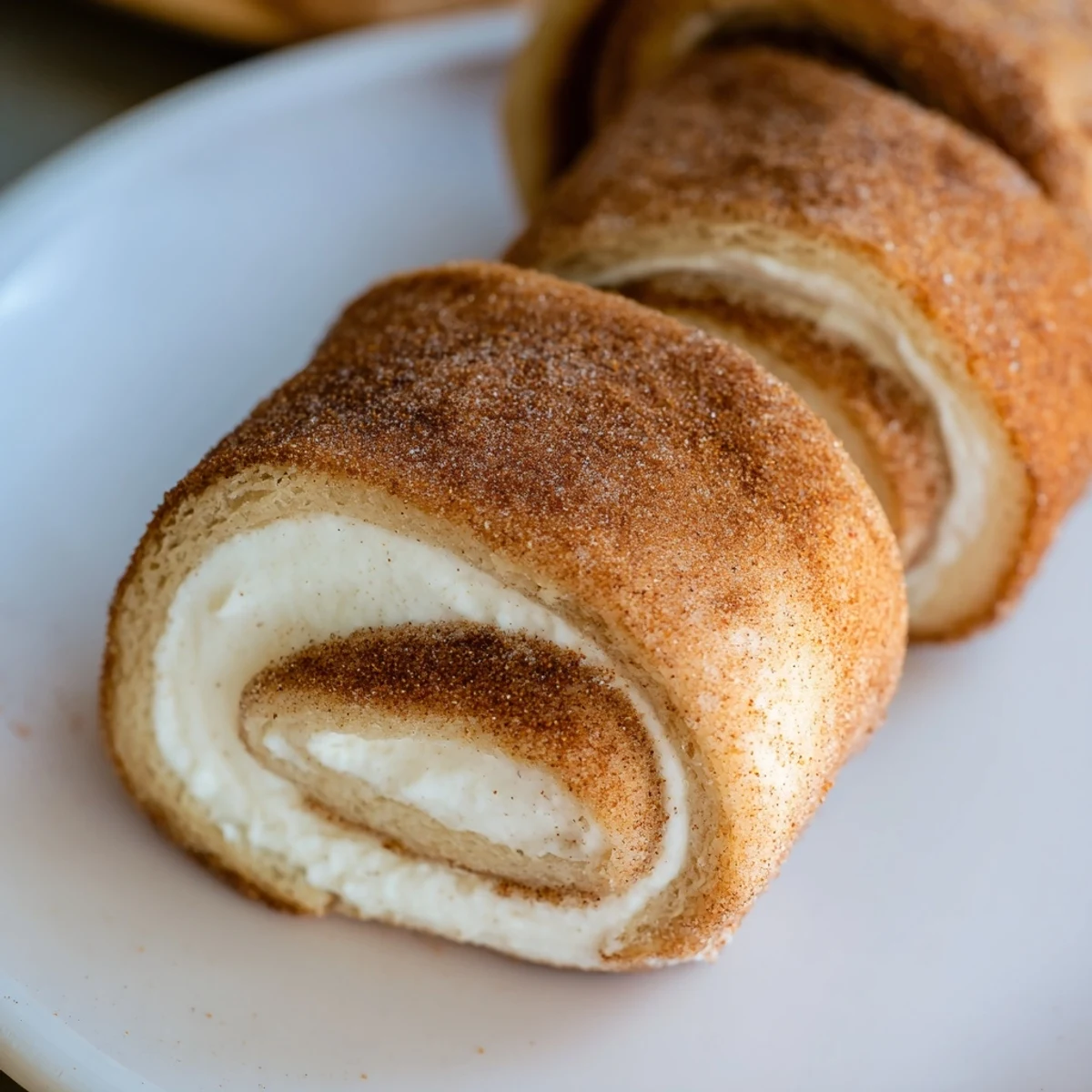 Warm, golden Easy French Toast Roll-Ups, perfectly dusted in cinnamon sugar, ready for a delicious breakfast.