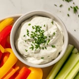 A vibrant image of the Kids Dip: Cream Cheese and Ranch Dip served with colorful crunchy veggie sticks.