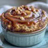 A fluffy single-serve Cinnamon Swirl Protein Banana Baked Oats, featuring a visible cinnamon ribbon and chopped walnuts for added crunch, perfect for a cozy morning meal.