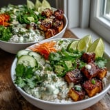 Crispy tofu cubes top fluffy jasmine rice and vibrant quick-pickled veggies in a banh mi bowl. 