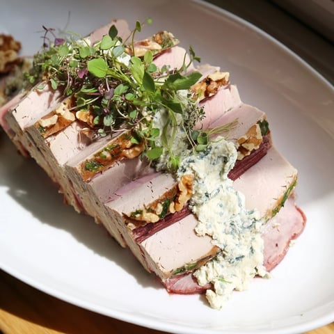 Vibrant layers of The Grand Canyon Rim terrine show sloping meat cliffs with blue cheese rivers.