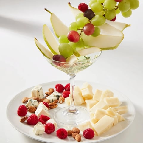 A beautiful Champagne Waterfall Board, spilling grapes, cheeses, and fruits for a celebratory treat.