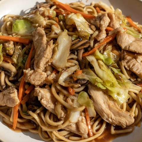 Delicious homemade Chicken Lo Mein, featuring vibrant vegetables in a rich sauce.  