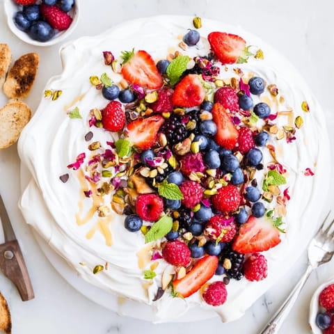A festive butter board dessert featuring creamy cheese, berries, and toasted nuts.  