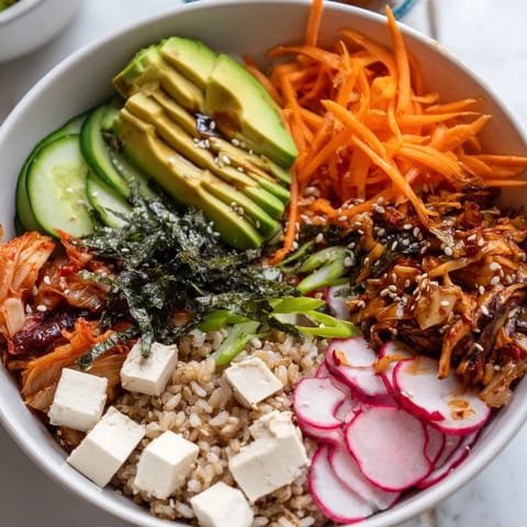 Vibrant fermented vegetable bowl brimming with kimchi, carrots, and cucumbers.  