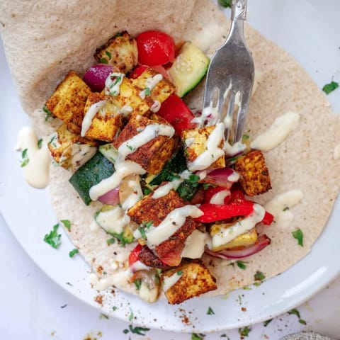 Delicious Vegan Viral Recipe re-make, featuring colorful roasted vegetables and tangy sauce.  