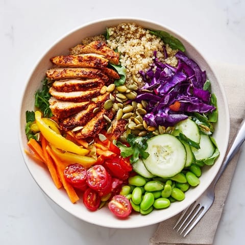 Colorful Healthy Meal-Prep Bowls brimming with quinoa, fresh veggies, and zesty dressing.  