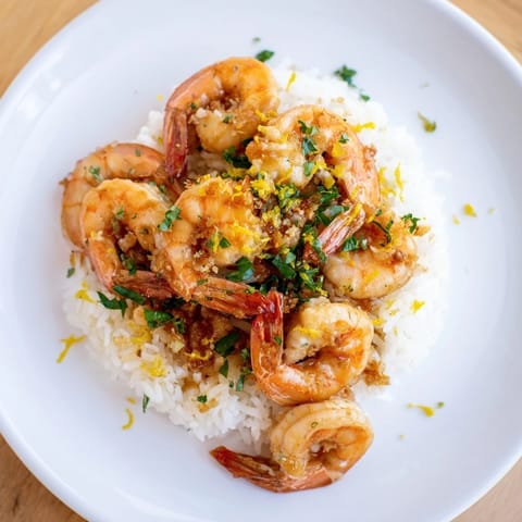 Flavors of a Garlic Butter Shrimp Rice Bowl: A close-up shows the shrimp, infused with savory garlic butter.