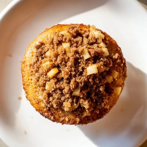 Warm, cinnamon-infused tasty apple muffins, perfect with coffee as a delicious homemade breakfast.
