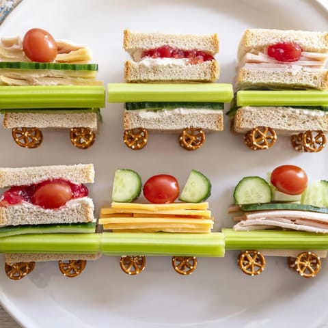 Colorful, fun Train Track Sandwich Board with creative veggie tracks, perfect for a kids' party.