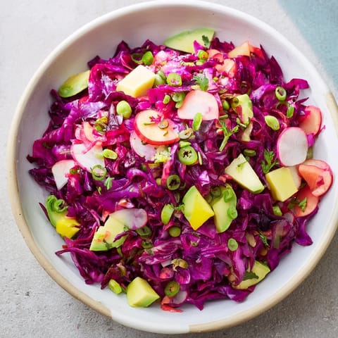 Brightly colored Green Goddess Detox Cabbage Salad, tossed in a zesty dressing and ready to serve.