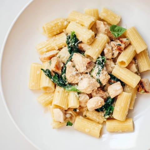 A comforting close-up showcases flavorful Budget-Friendly Marry Me Chicken Pasta, garnished with fresh basil.