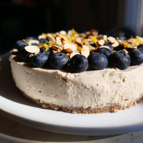 Tempting no-bake Protein Cheesecake Cups, showcasing a creamy filling over a golden, crunchy base.