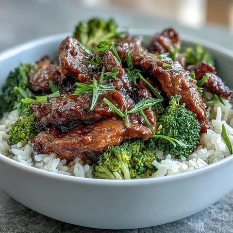 Steaming Beef and Broccoli Bowl served hot with juicy beef, vibrant green broccoli, and savory sauce.