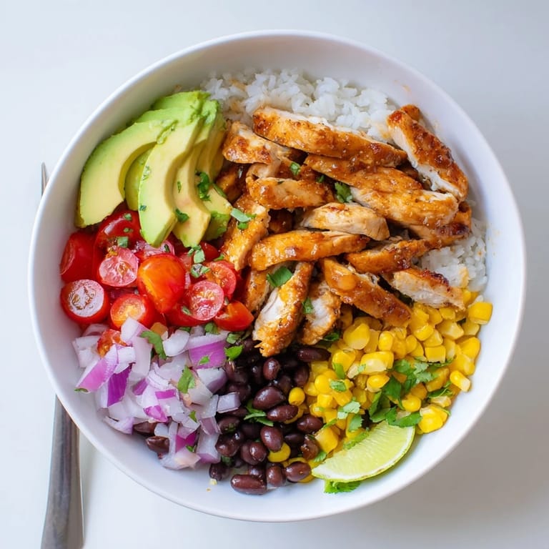 Delicious Honey Chipotle Chicken Rice Bowls drizzled with zesty lime dressing and fresh veggies.