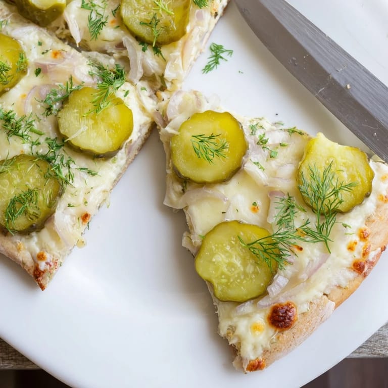 Savor the unique Pickle Pizza, combining rich crème fraîche and zesty toppings.