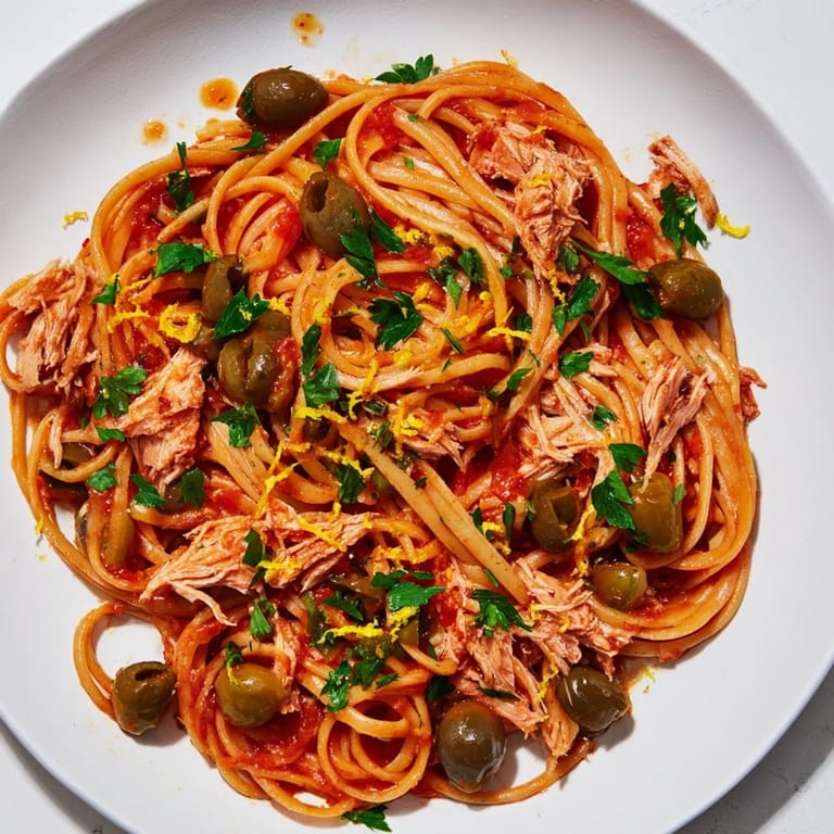 This Pasta with Tuna, Olives & Capers features glistening tomatoes and perfectly cooked pasta, ready to serve.