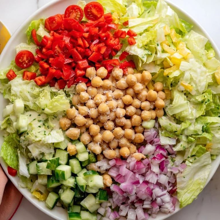 A close-up of La Scala Chopped Chickpea Salad, a delicious vegetarian meal bursting with fresh, chopped ingredients.