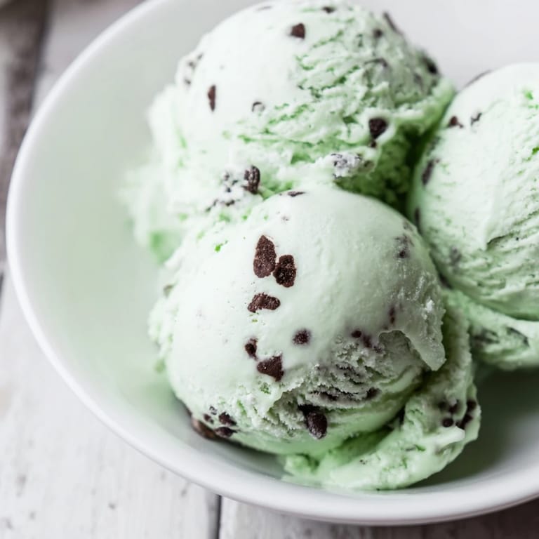 A close-up of freshly churned Mint Chocolate Chip Ice Cream, offering a delightful frozen dessert.